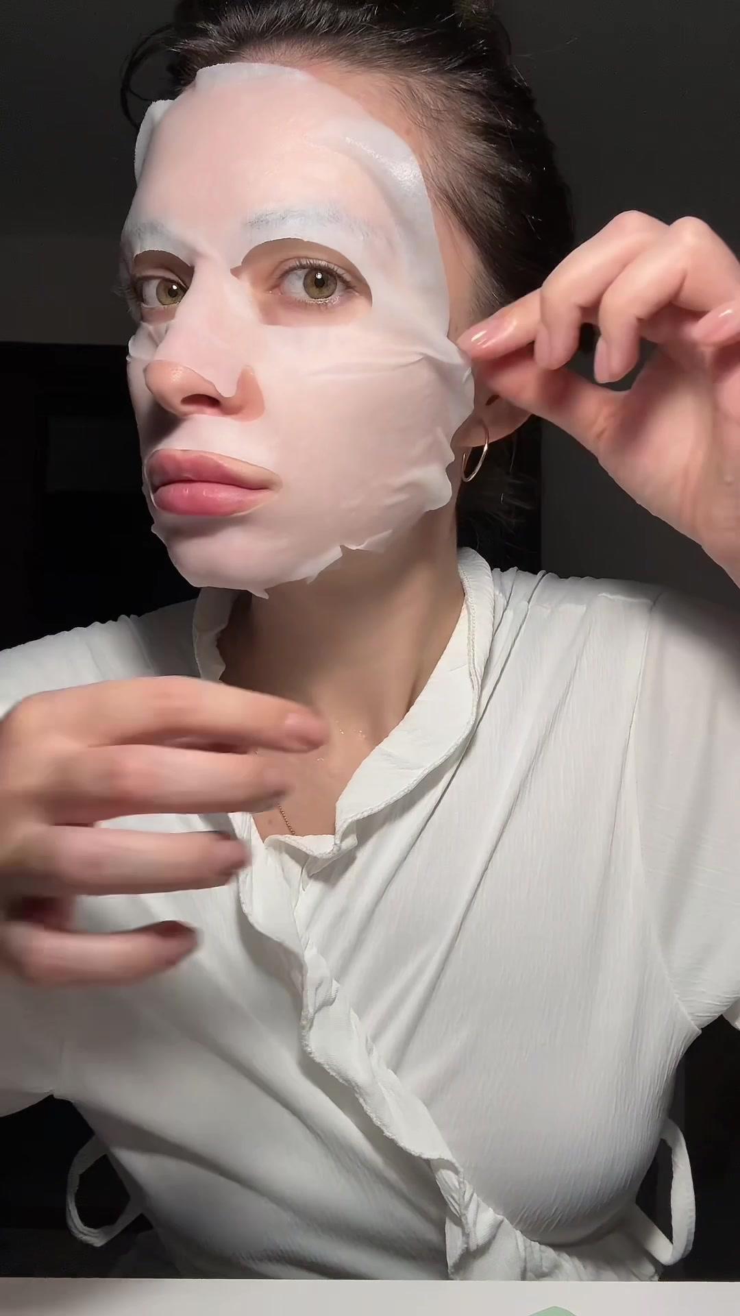 Woman Adjusting Sheet Mask On Face